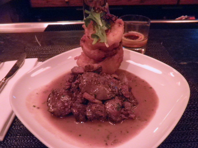 Chicken livers and onion rings with house bacon and pan jus